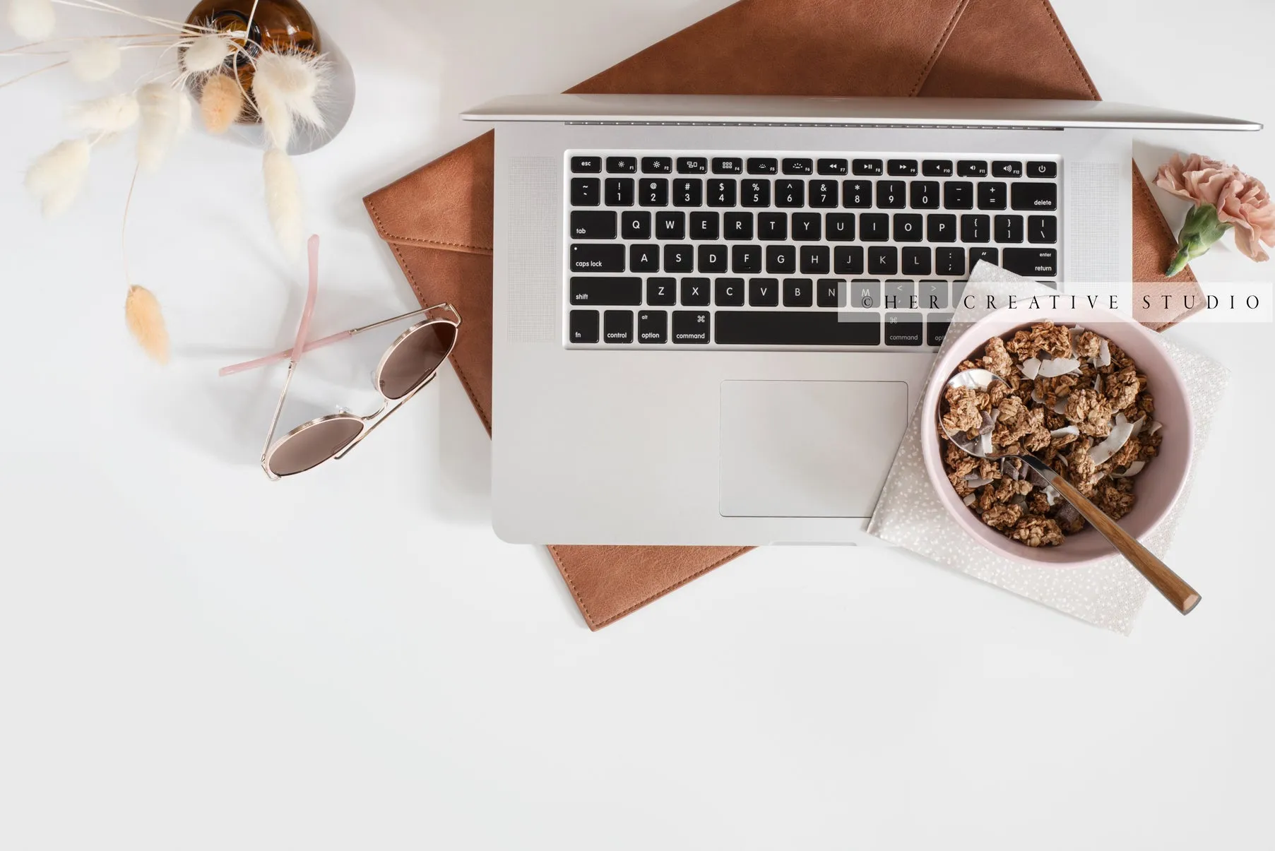 Granola & Bunny Tail ontop of Laptop. Digital Image.