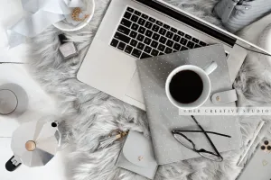 Laptop & Coffee on Grey Workspace. Stock Image