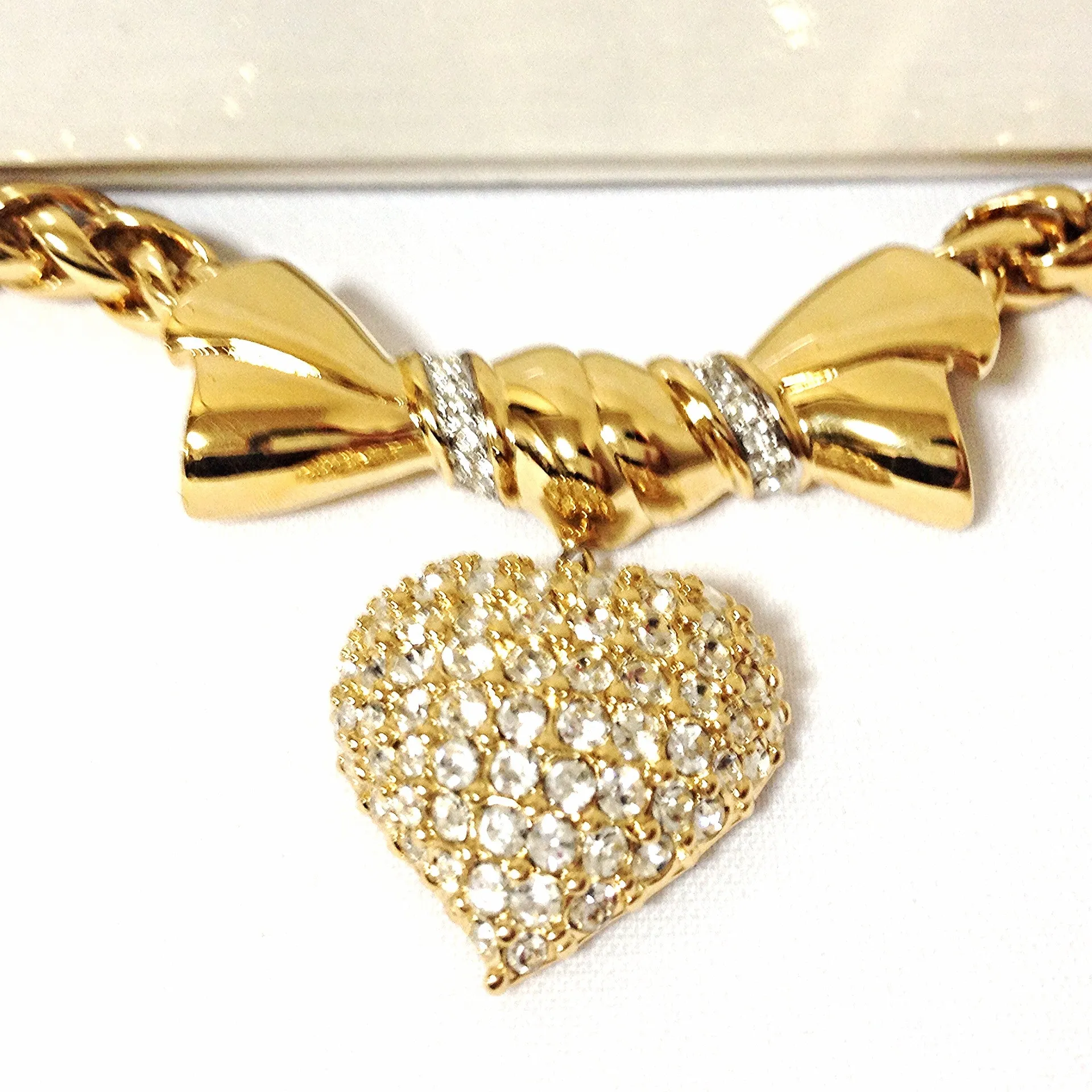 MINT. Vintage Nina Ricci golden chain statement necklace with ribbon bow and crystal stone heart pendant top. Perfect vintage jewelry